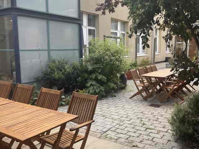 Outdoor courtyard for events with modular teak furniture for networking and breakout sessions.