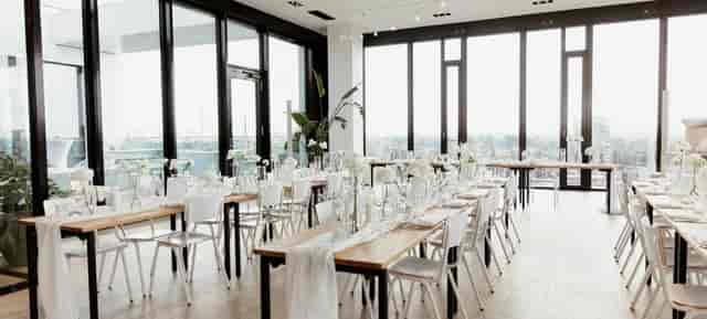 Amsterdam Lounge minimalist banquet hall with floor-to-ceiling windows for luxury event styling.