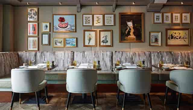 Sophisticated Breidenbacher Hof restaurant with banquette seating for corporate business dinners.