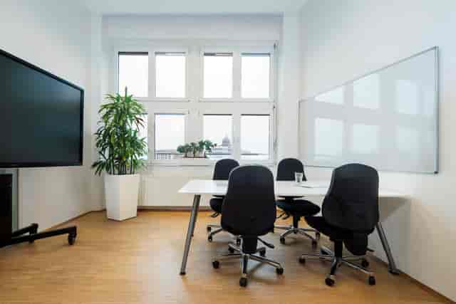 Minimalist RWI4 breakout room with AV and whiteboard for strategy sessions or team collaborations.
