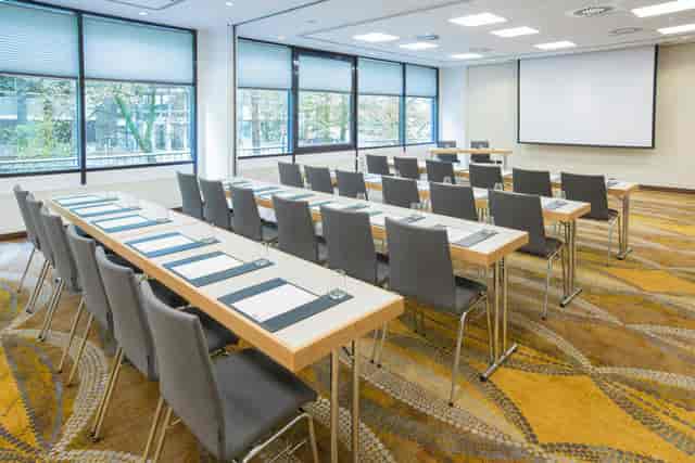 Classroom-style conference suite with natural light for corporate training and seminars.