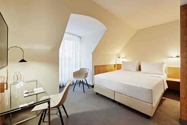 Minimalist hotel room in Lindner Hotel Dusseldorf, ideal for business travel and corporate stays.