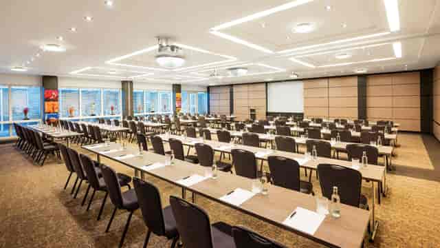 Classroom-style boardroom in Hotel Duesseldorf with natural light for corporate workshops.
