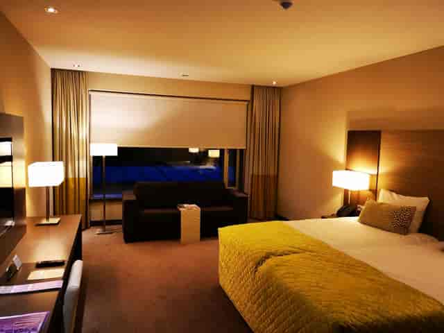 Modern hotel room with workspace for corporate travel and business meetings in Amsterdam.