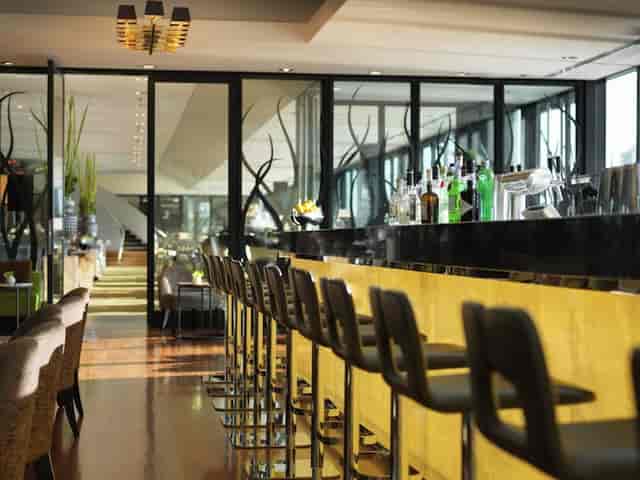 Modern hotel lounge and bar for upscale corporate networking and evening reception events.