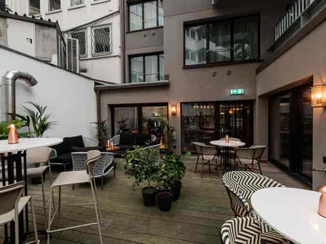 Modern urban patio meeting room for networking and coffee breakout sessions.