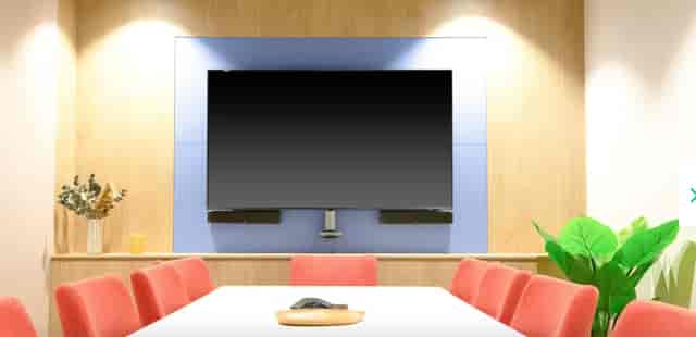 Modern meeting room in Runway East Birmingham with red chairs, ideal for events and presentations.