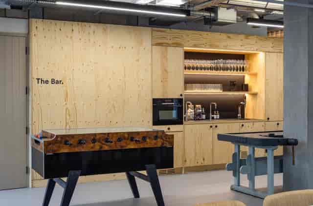 Modern bar area with foosball table for casual networking events.