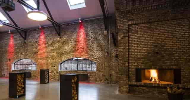 Industrial-chic event venue with exposed brick, perfect for evening receptions and lounge events.
