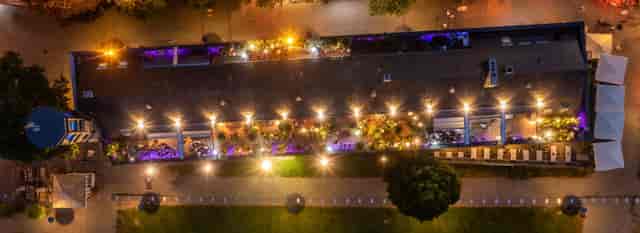 Rheinloft Cologne rooftop lounge with purple ambient lighting for networking and cocktail events.