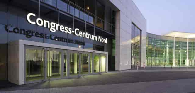 Gürzenich Köln convention center entrance with glass facade for corporate events and conferences.
