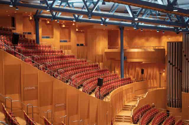 Kölner Philharmonie auditorium with warm wood paneling for professional events and conferences.