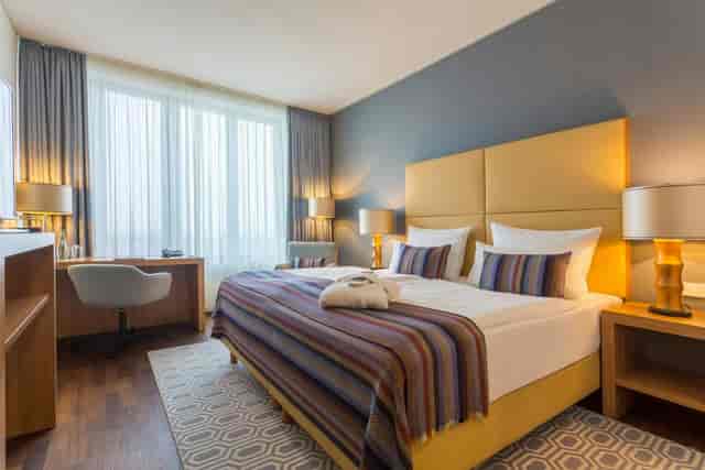 Modern hotel room at AMERON Köln Hotel Regent for business travel and conferences.