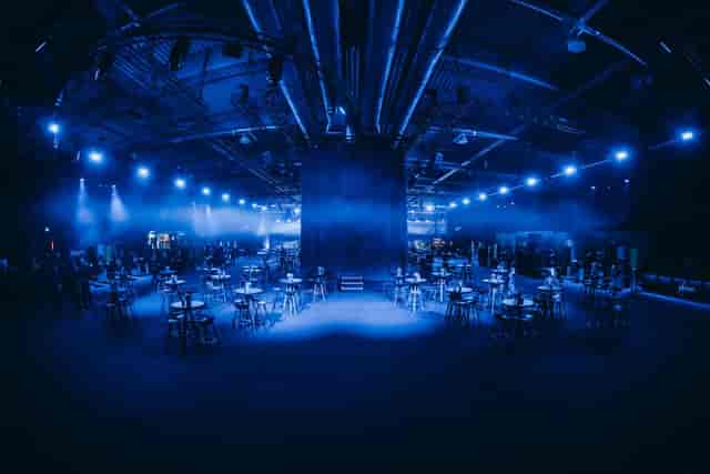 Industrial networking reception at XPOST Conference Center with sleek blue mood lighting.