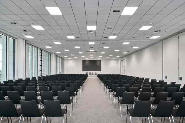 Theater-style conference center with natural light for corporate events and presentations.