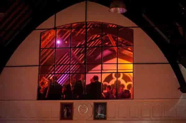 Priory Community Hall mezzanine with dynamic event lighting for social mixers and receptions.