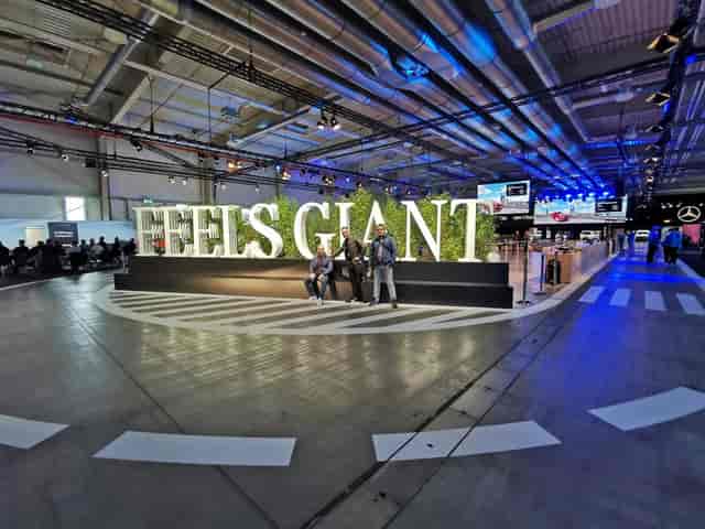 Experiential trade show booth at EXPO XXI with dimensional signage and greenery for event marketing.