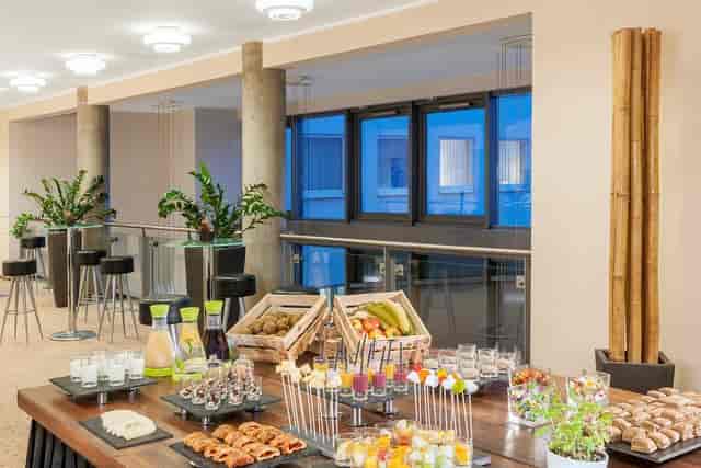 Refreshment station with high-top seating for corporate events and networking coffee breaks.
