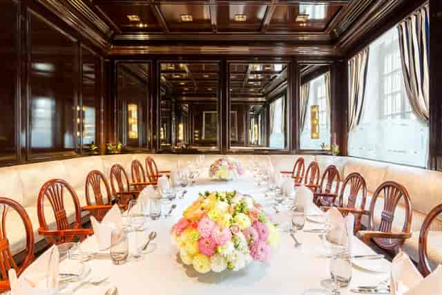 Upscale Excelsior Hotel Ernst boardroom with dark wood for executive meetings or gala dinners.