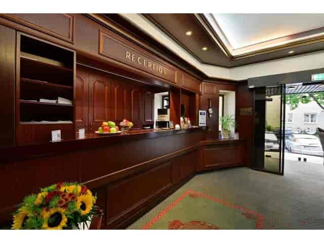 Classic hotel reception desk at Hotel Imperial Köln, ideal for personalized guest check-in.
