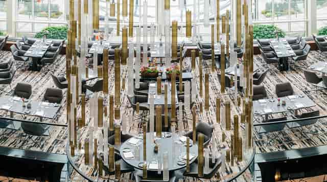 Upscale Glashaus Restaurant dining room with sculptural installation for gala event venue.