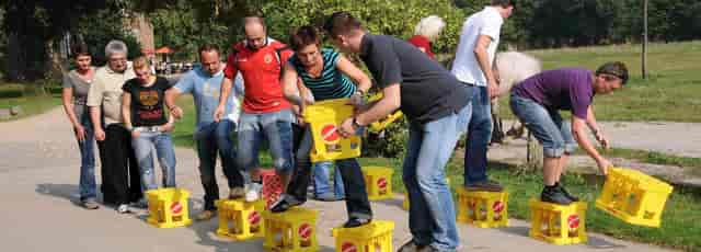 Team Challenge icebreaker at Zollverein: outdoor team-building event using repurposed materials.
