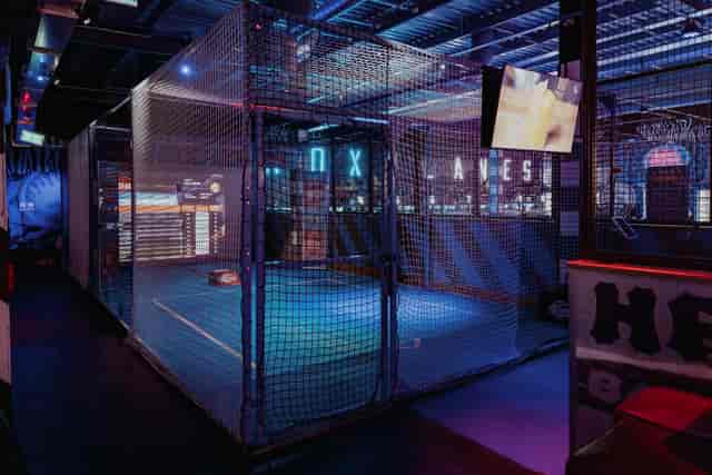 Vibrant Roxy Lanes venue with netted bowling area for corporate events and team-building.