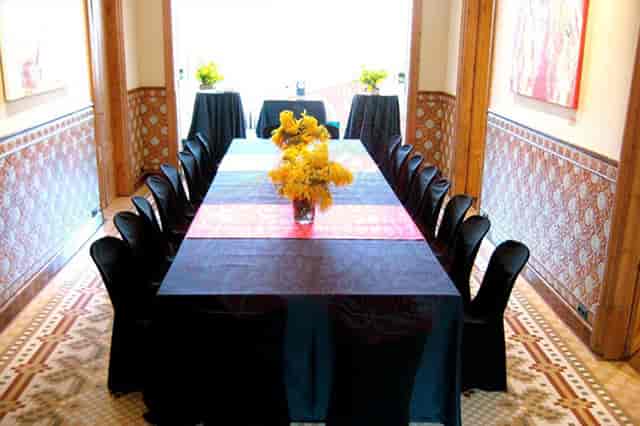 Boardroom meeting setup with black table at Torre Amat, ideal for corporate events or luncheons.