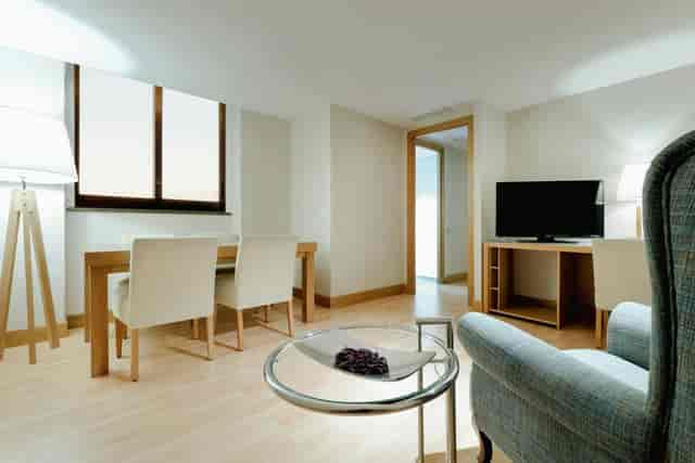 Pedralbes suite at Hesperia Barcelona with conference table for executive meetings and events.