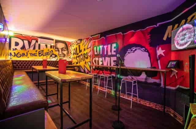 Karaoke room at Roxy Ball Room Sheffield with colorful mural for events and gatherings.