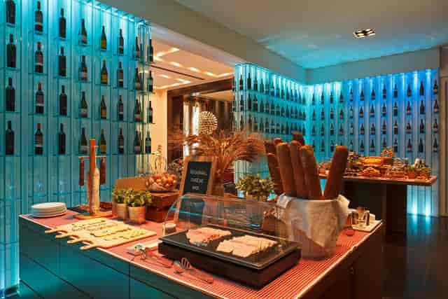 Rustic charcuterie station with architectural lighting for corporate reception or networking event.