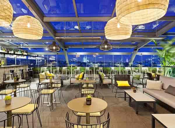 Modern rooftop bar with lounge seating for networking events and sunset cocktail receptions.