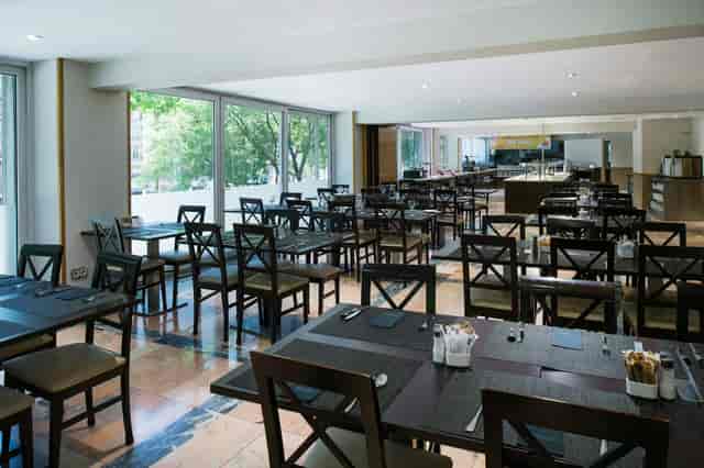 Corfu hotel restaurant space with natural light, perfect for corporate events and wedding banquets.