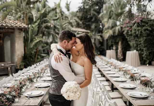 Al fresco wedding at Masia Victoria, featuring a long-table garden setup for elegant ceremonies.