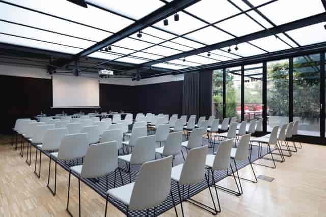 Modern Alexandra Barcelona Hotel meeting room in classroom style for corporate training workshops.