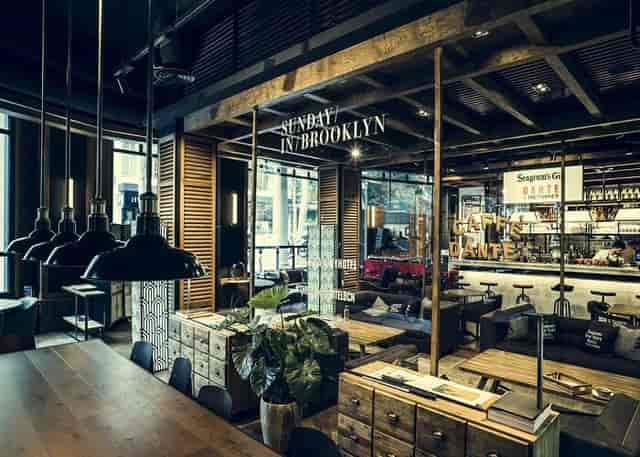 Industrial-chic Corner Hotel bar with ambient lighting for VIP networking and client mixers.