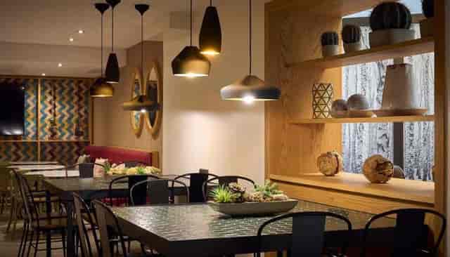 Modern Catalonia Gastrobar with pendant lighting for professional networking and corporate events.