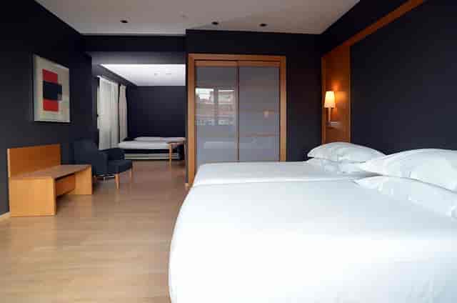 Contemporary Universal Room hotel suite for VIP business meetings and remote work.