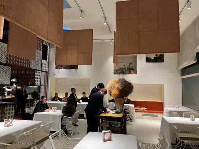 Upscale Disfrutar Barcelona dining room, sleek decor for corporate dinners and board retreats.
