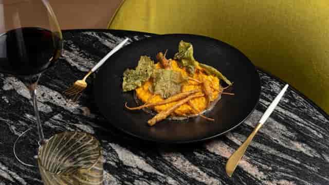 Vegetarian entrée on black stoneware for executive dinner at Almanac Barcelona.