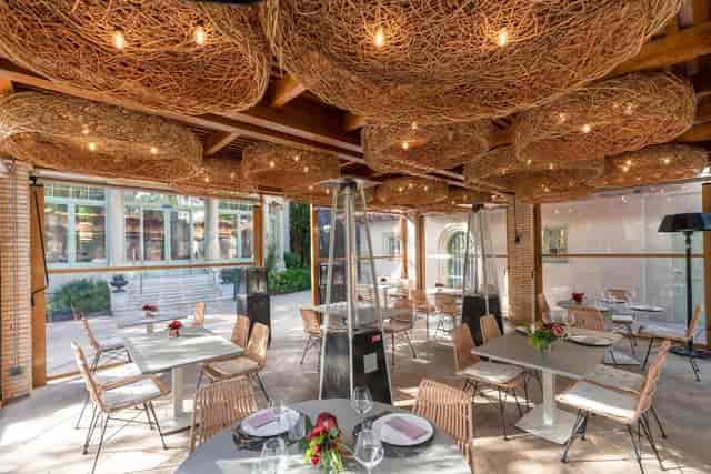 Upscale outdoor hotel reception with patio heaters for intimate events and luxury weddings.