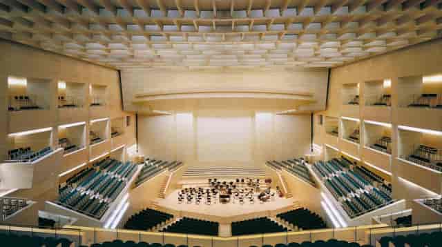Auditori L'illa foyer: sophisticated tiered seating for corporate keynote and gala events.