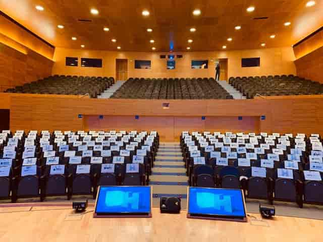 Auditori L'illa foyer with socially distanced seating for corporate events and conferences.