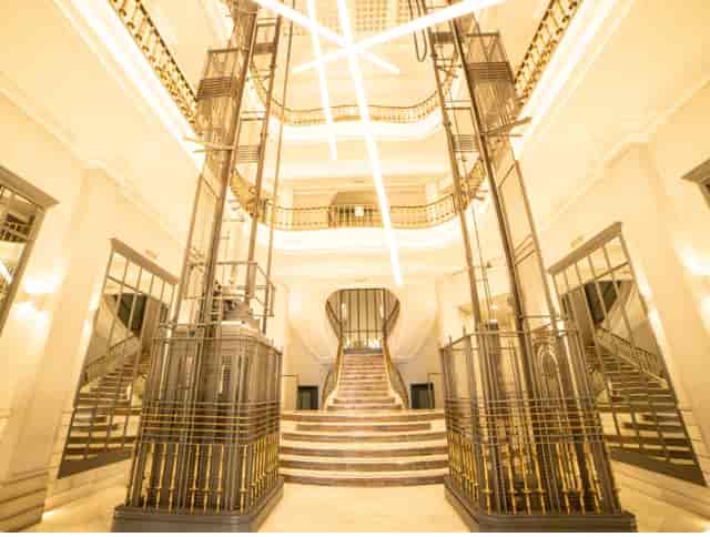 Grand historic staircase and atrium at Hub Gran Vía for luxury brand activations and gala events.