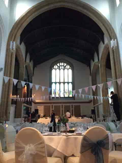 Church Hall event venue prep with bunting and sound equipment for weddings and conferences.