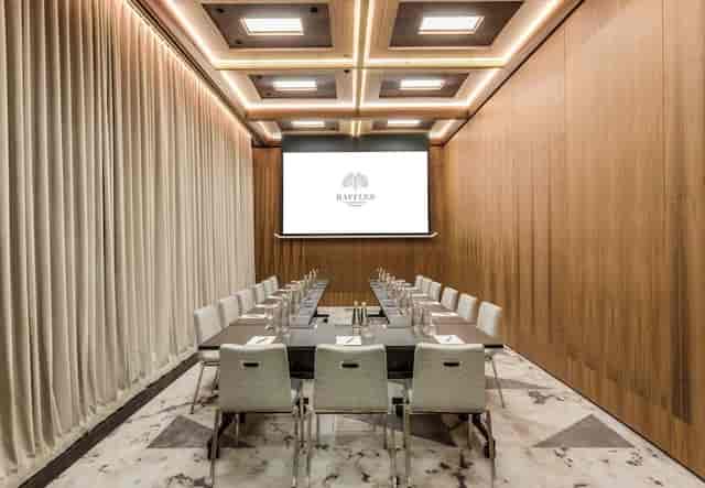 U-shape boardroom at Raffles Warsaw featuring wood paneling for executive meetings and events.