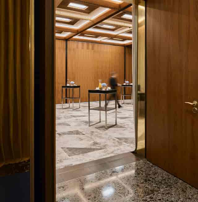VIP networking break in Three Colours Room, Raffles Warsaw with elegant wood paneling.