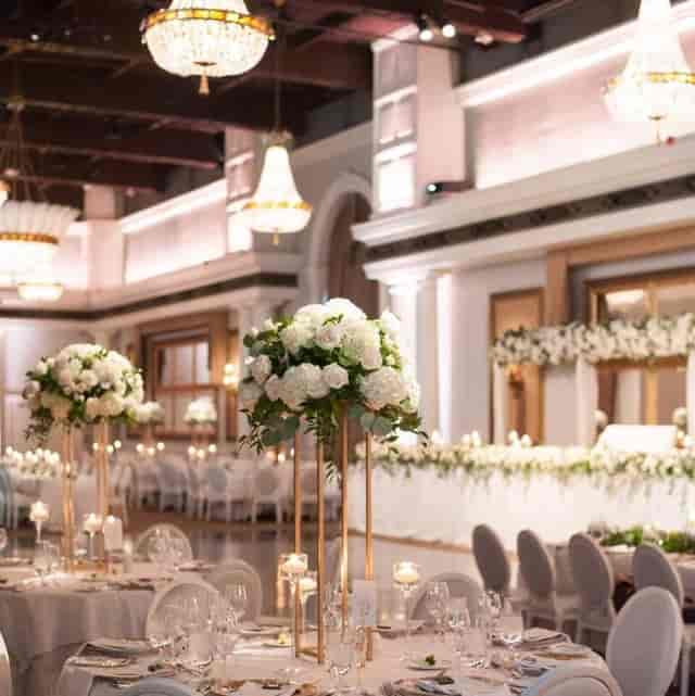 Luxury Renaissance Room wedding gala with gold accents and tall floral centerpieces.