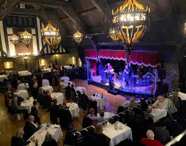 Old Mill Toronto dining room with stage for cabaret-style dinner theater and historic architecture.