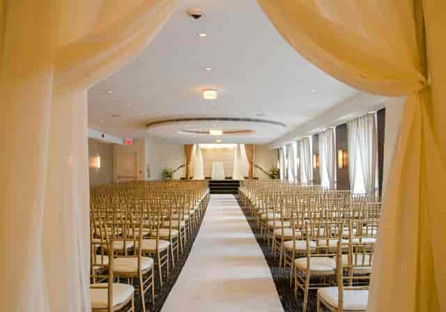 The Eglinton Grand theater-style ceremony with white aisle runner for corporate events or weddings.